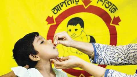 administering_vitamin_a_capsule_to_a_young_girl