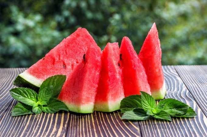 Fresh sliced watermelon wooden old background