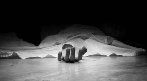 The dead man’s body. Focus on hand
