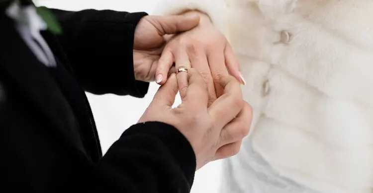 groom-is-putting-wedding-ring-hi