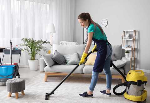woman-vacuuming-carpet-in-living-room