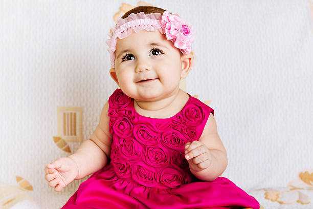 Cute baby girl in pink floral dress