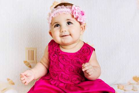 Cute baby girl in pink floral dress